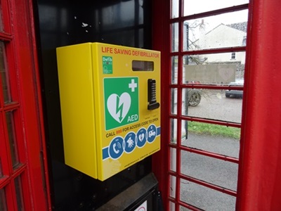 Lifesaving defibrillator box outside Watton at Stone Parish Council building, accessible AED device.