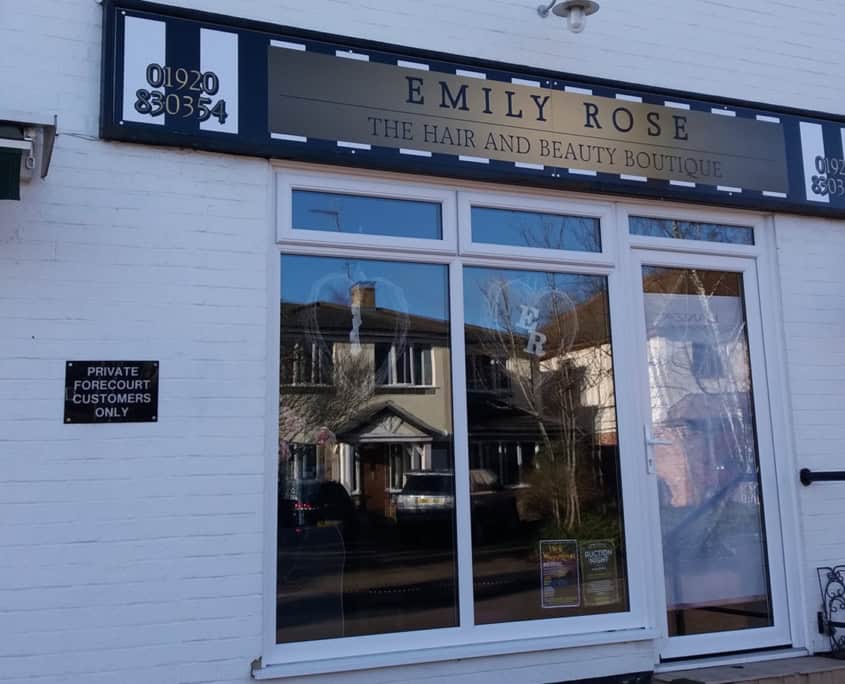 A colourful shopfront with large windows and a sign for Emily Rose Hair and Beauty Boutique.